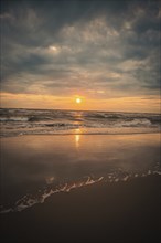 Beach with waves by the sea at sunset, Zandvoort, Netherlands