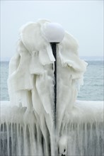 Streetlamp covered with ice, ice sculpture, Lake Geneva, Versoix, Canton Geneva, Switzerland,