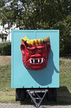 Devil's grimace, face of a monster with fangs and horns on a fairground float, Rheinkirmes,