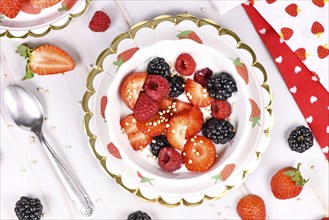 Top view of berry mix yogurt bowl with strawberry, raspberry and blackberry fruits and puffed