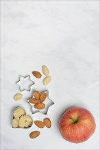 Almonds and biscuit cutters for biscuits, almond kernels, apple