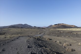 Path through the volcanic landscape to the Caldera de Los Cuervos volcano, Tias, Lanzarote, Canary