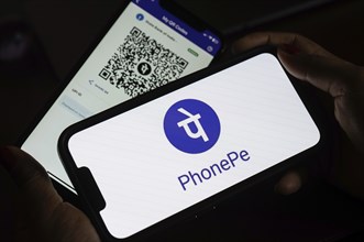 In this photo illustration, the PhonePe QR code, is seen displayed on mobile phones screen in