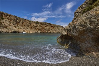 Menies, Rodopou, dream bay, single boat at anchor, spray, rocks, pebble beach, crystal clear sea,