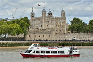 Sightseeing boat on the Thames in front of the Tower of London, London, England, United Kingdom,