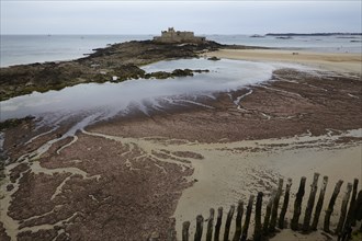 Fort National with mudflats at low tide on a tidal island off Saint-Malo, Ille-et-Vilaine,