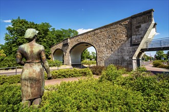 Sculpture Konerin in front of stone arch bridge Premnitz, Brandenburg, Germany, Europe