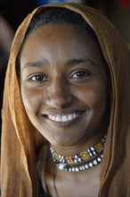 Young girl from a nomadic tribe, wearing headgear, portrait, Bayuda Desert, in Karima, Nubia,