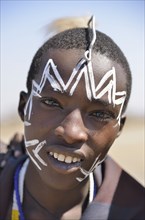 Young Maasai warrior with a painted face, Ngorongoro Conservation Area, Ndema, Tanzania, Africa