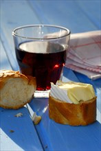 Soft cheese with baguette and glass of red wine