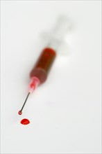 Injection syringe with cannula and red liquid, syringe, disposable syringe