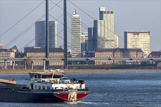 Düsseldorf, city centre skyline, skyscrapers, Rheinkniebrücke, Rhine, cargo ship