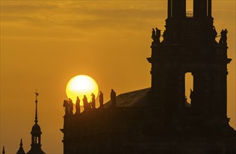 Sunset in Dresden. The sun disc, particularly orange due to the Sahara dust, sets behind the