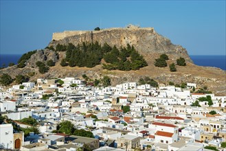 Town of Lindos with white houses, Acropolis of Lindos in the back, Lindos, Rhodes, Dodecanese,