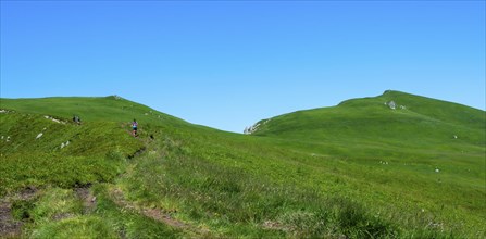 Hikers in the Monts Dore mountains in Auvergne Volcanoes Natural Park, Sancy Massif, Puy de Dome