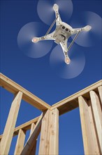 Drone unmanned aircraft system flying to inpect a house wood construction framing being built