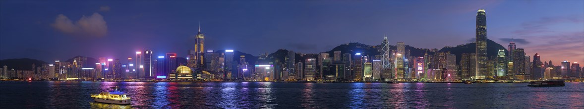 Panorama of Hong Kong skyline cityscape downtown skyscrapers over Victoria Harbour in the evening