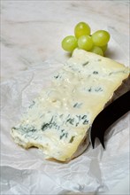 Gorgonzola cheese with cheese knife and grapes, blue cheese, noble mould