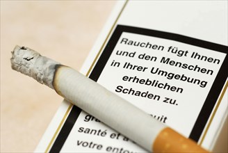 Burning cigarette and warning on pack, cigarette pack, smoking, warning, cigarettes