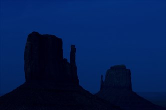 Rock formation the Mittens, sandstone rocks silhouetted at night, Monument Valley Navajo Tribal