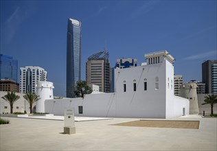 Old fort and museum Qasr al Hosn in front of skyscrapers, oldest building in Abu Dhabi City,