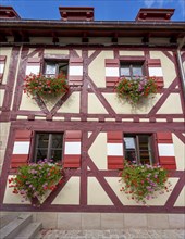 Facade with flowers on the windows, half-timbered house in the castle, in autumn, Nuremberg, Middle