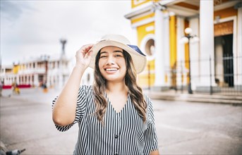 Portrait of beautiful tourist girl in the tourist square. Granada, Nicaragua. Portrait of happy