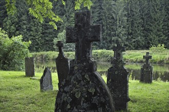 Headstones on 17th and 18th century graves of the old graveyard along the Semois river at Mortehan,