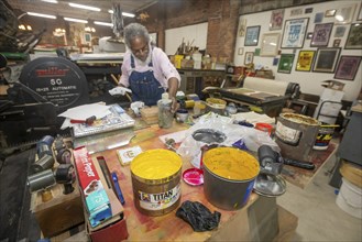 Detroit, Michigan, Amos Kennedy works in his letterpress printing shop. Kennedy prints posters and