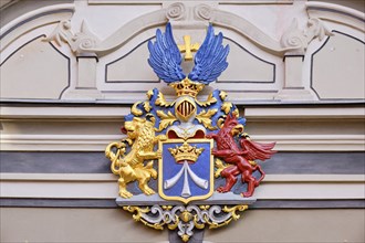 The town coat of arms from the Swedish occupation period on the gable of the baroque grand portal