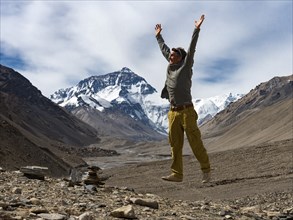 Man jumping for joy in front of Mt Everest summit, Tibet, China, Asia