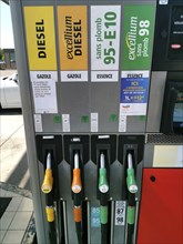 Petrol pump with nozzles for petrol and diesel at a motorway filling station in France