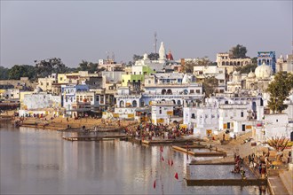 PUSHKAR, INDIA, NOVEMBER 20, 2012: Hindu devotees pilgrims bathing in sacred Puskhar lake (Sagar)