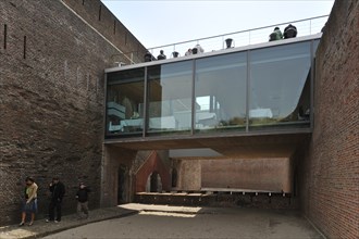 Restaurant with terrace and tourists with audio guides at Fort Napoleon in the dunes near Ostend,