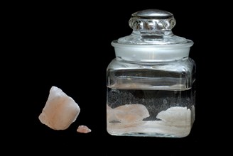 Saturated salt solution in glass container, brine, salt-water solution, Himalayan salt, salt