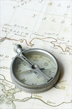 Old compass on map, orientation, discovery, explorer