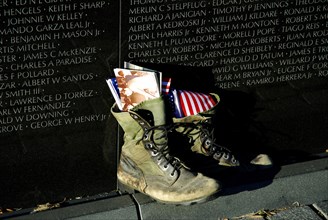 Shoes in front of Vietnam War memorial plaque, Memorial, DC, Vietnam Veterans Memorial, Washington