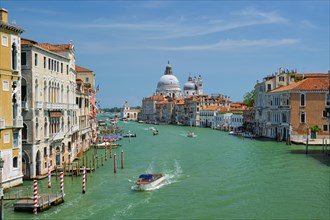 View of Venice Grand Canal with boats and Santa Maria della Salute church in the day from Ponte