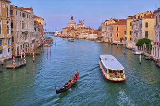 VENICE, ITALY, JULY 19, 2019: View of Venice Grand Canal with boats gondola and vaporetto and Santa