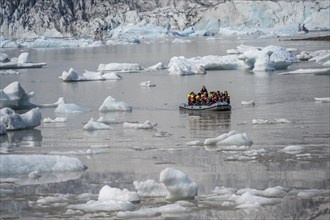 Boats with tourists in the glacier lagoon, ice lagoon Fjallsárlón, ice floes in front of glacier