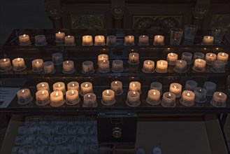 Offering candles in the parish church of Maria Opferung, Riezlern, Kleinwalsertal, Austria, Europe