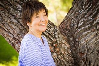 Outdoor portrait of a happy senior adult chinese woman