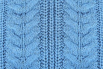 Close up of knitted pattern on blue wool pullover