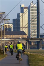 Düsseldorf, city centre skyline, skyscrapers, Rheinkniebrücke, Rhine, cyclists on the Rhine