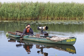 Nature park photographer in a kayak on the river Trebel at work, Naturpark Flusslandschaft