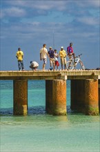 Fishers standing on pier in the sea. Santa Maria. Sal. Cabo Verde. Africa