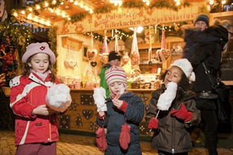 Children eat candy floss at the Striezelmarkt in Dresden