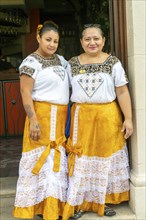 Two waitresses dressed in traditional Mayan clothing at Marganzo restaurant, Campeche city,