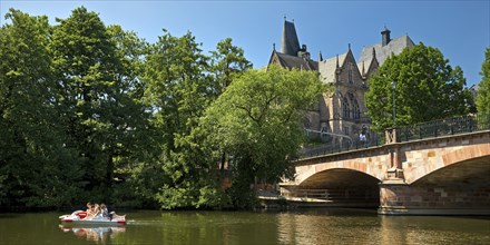 Pedal boat on the river Lahn with the Old University and the Weidenhäuser Bridge, Marburg, Hesse,