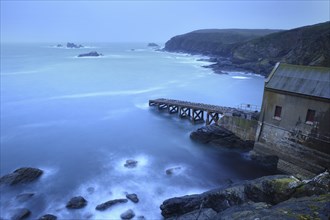 Abandoned boat ramp on rocky coast at dusk, mystical atmosphere, The Lizard, Cornwall, England,